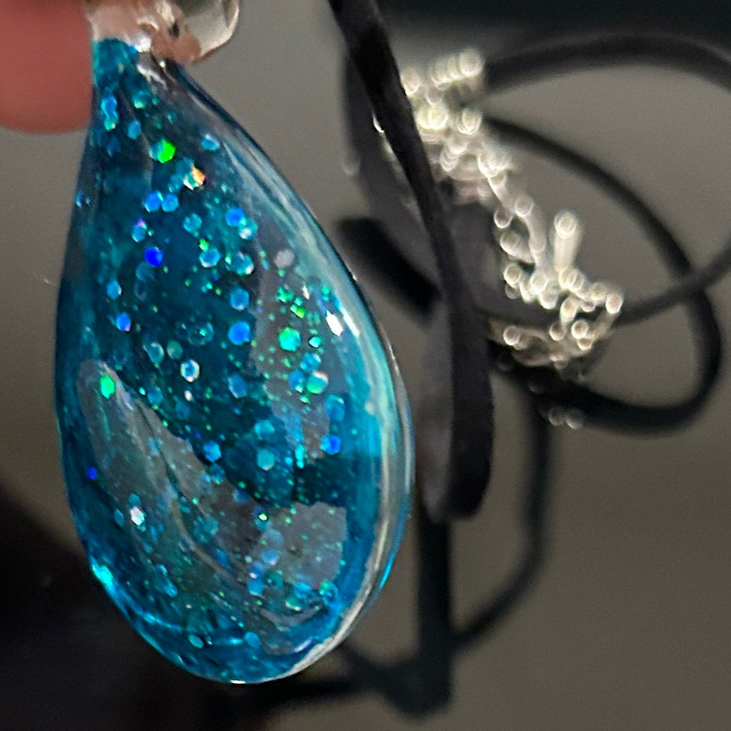 Handmade botanical dichroic glass teardrop pendant 2 inches with real dried grass straws suspended inside blue glass on 21 inch cloth chain