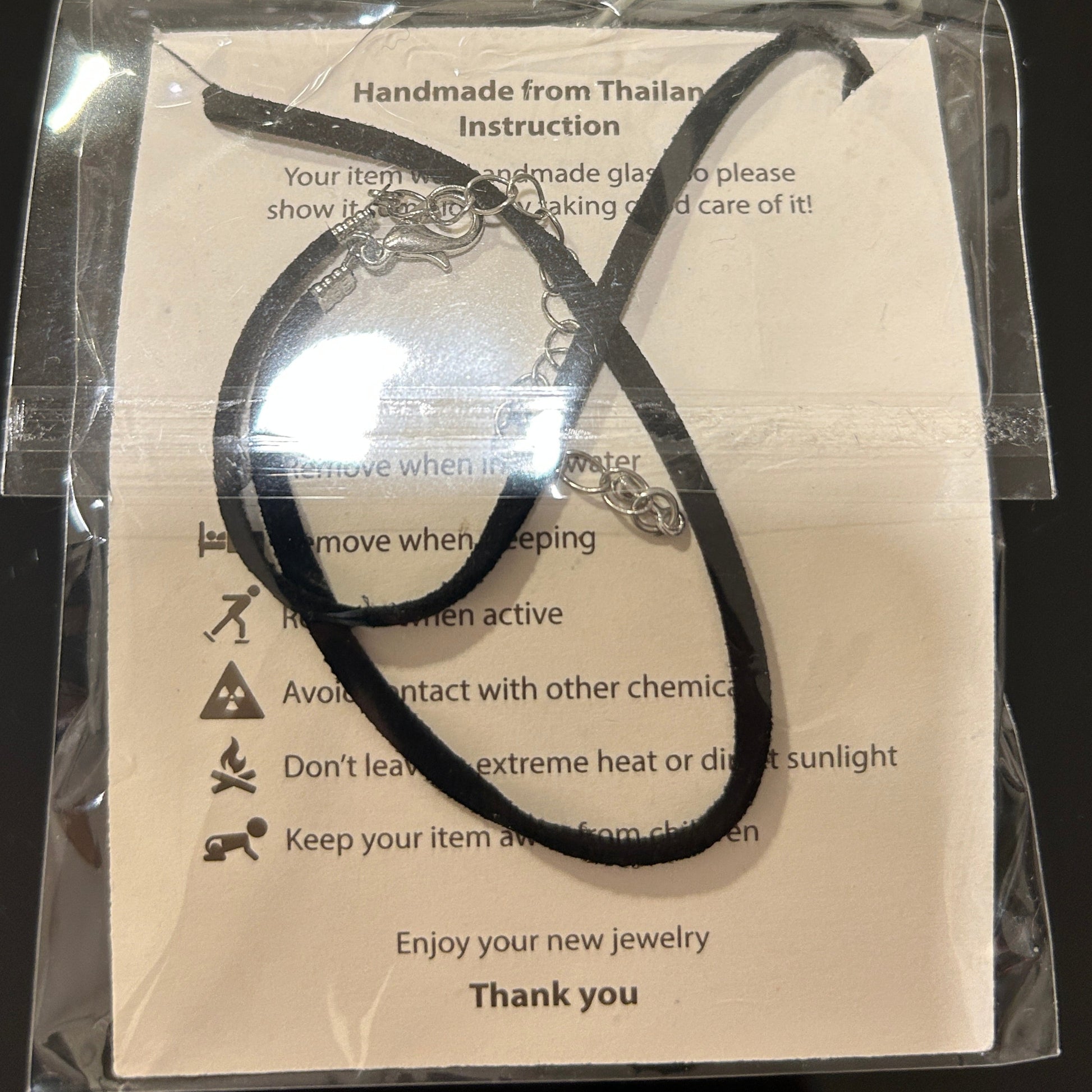 Handcrafted dichroic glass floral pendant with silver metallic flower design against dark background, Mars Glass artisan jewelry collection