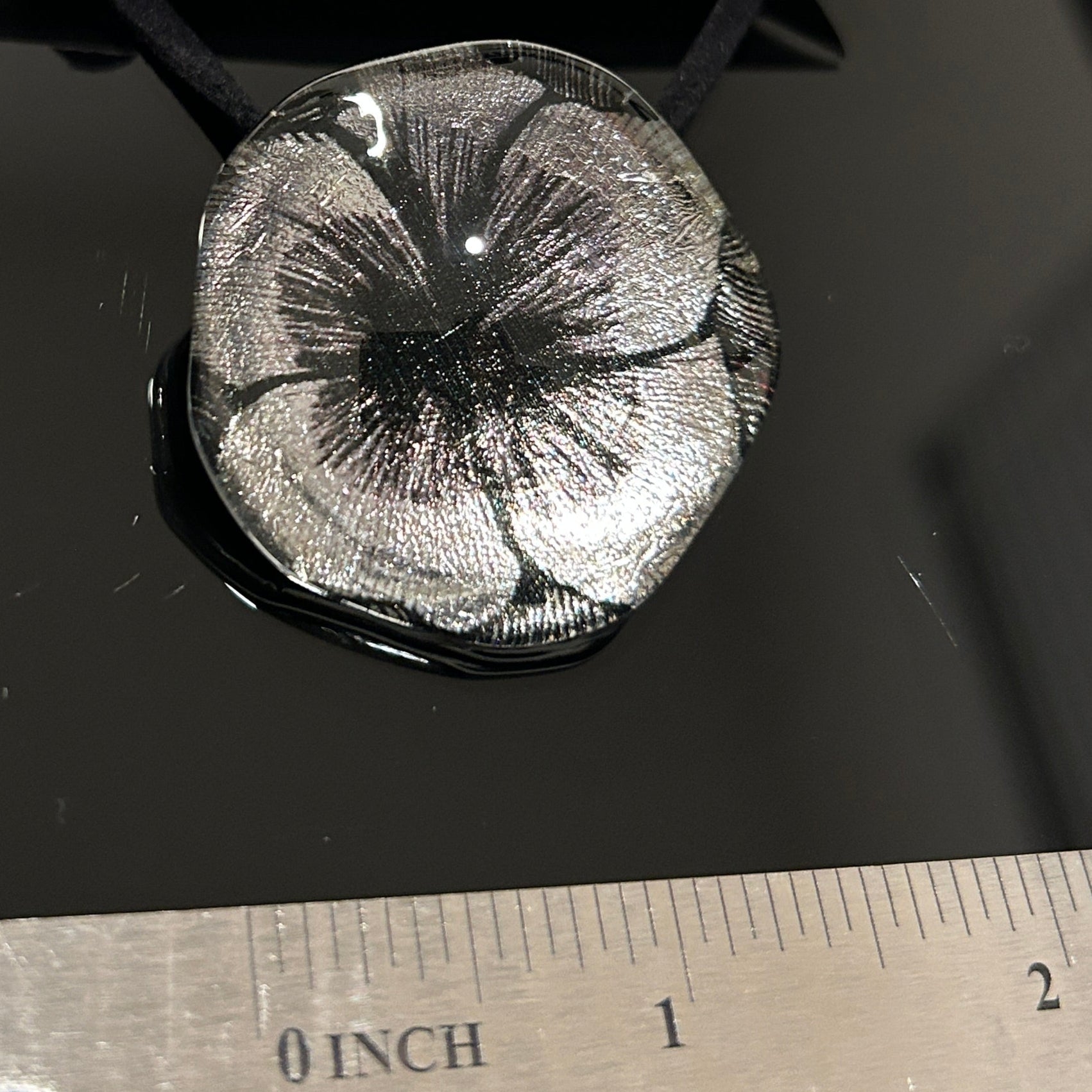 Handcrafted dichroic glass floral pendant with silver metallic flower design against dark background, Mars Glass artisan jewelry collection