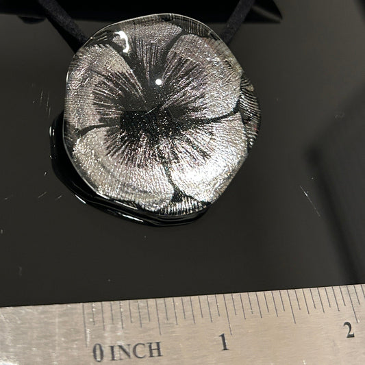 Handcrafted dichroic glass floral pendant with silver metallic flower design against dark background, Mars Glass artisan jewelry collection
