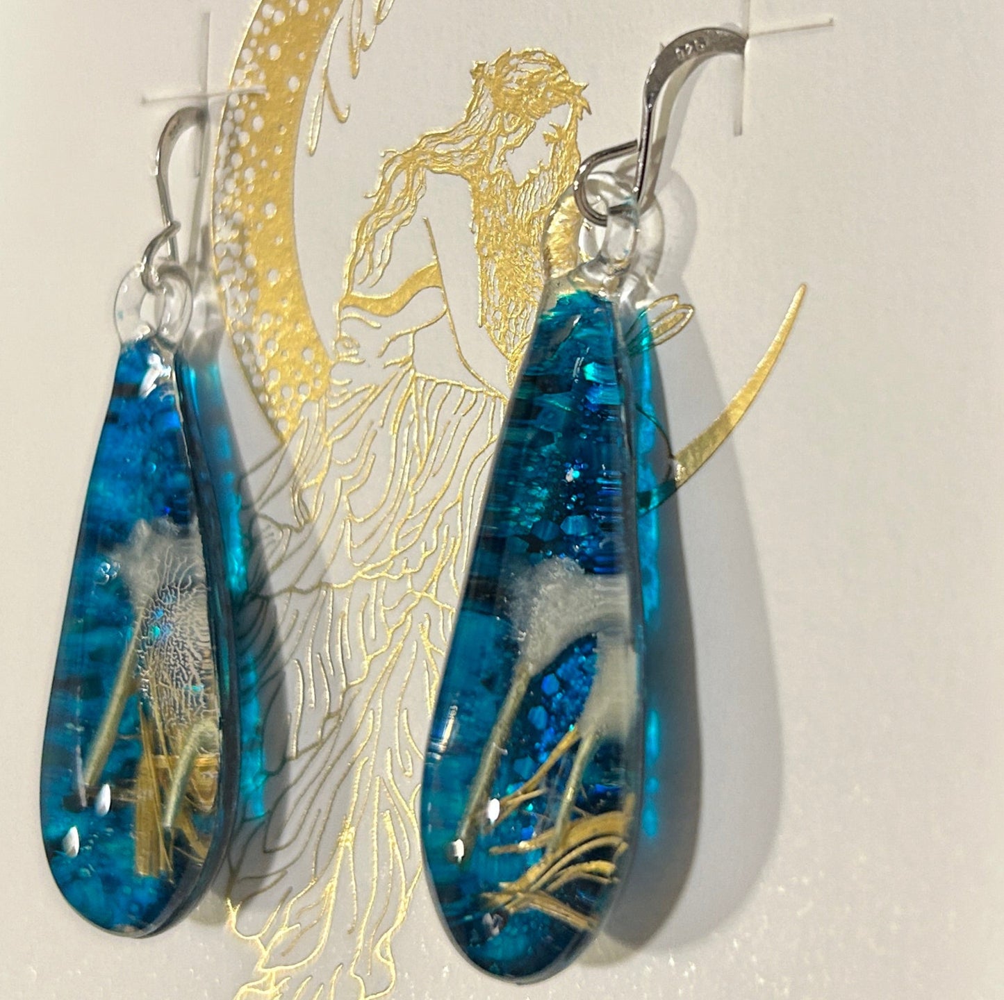 Handmade botanical dichroic glass drop earrings 2.1 inches long with real dried grass straws suspended in blue glass on sterling silver ear wires