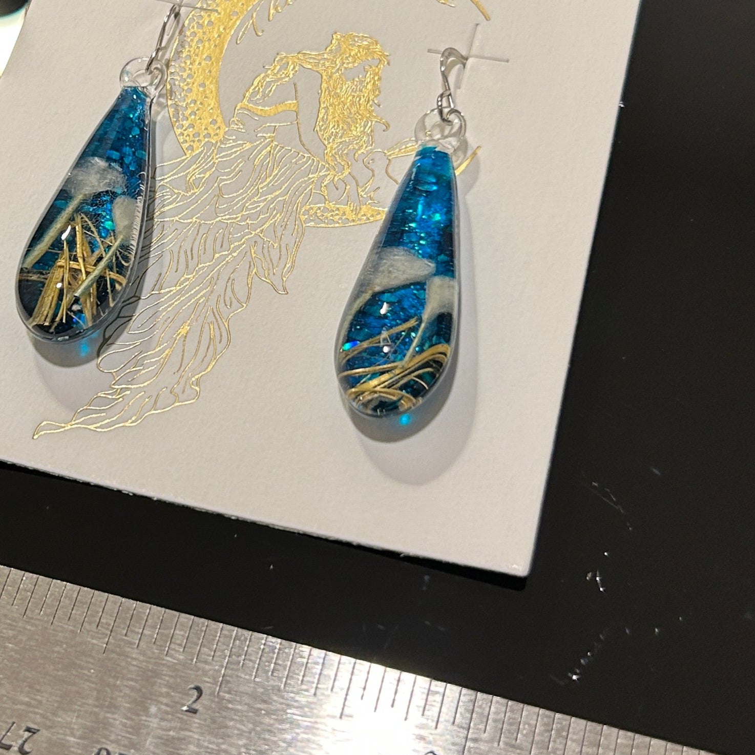 Handmade botanical dichroic glass drop earrings 2.1 inches long with real dried grass straws suspended in blue glass on sterling silver ear wires