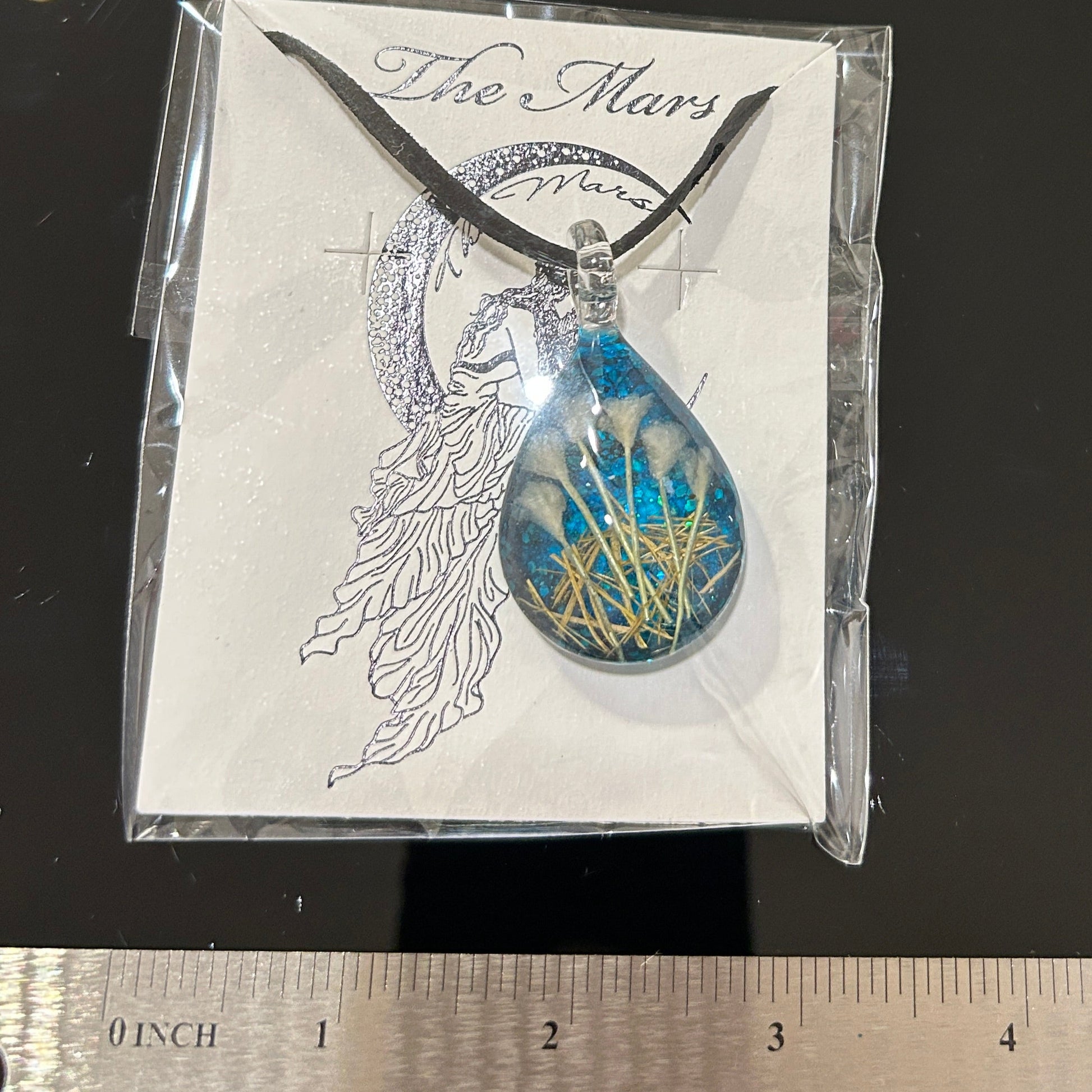 Handmade botanical dichroic glass teardrop pendant 2 inches with real dried grass straws suspended inside blue glass on 21 inch cloth chain