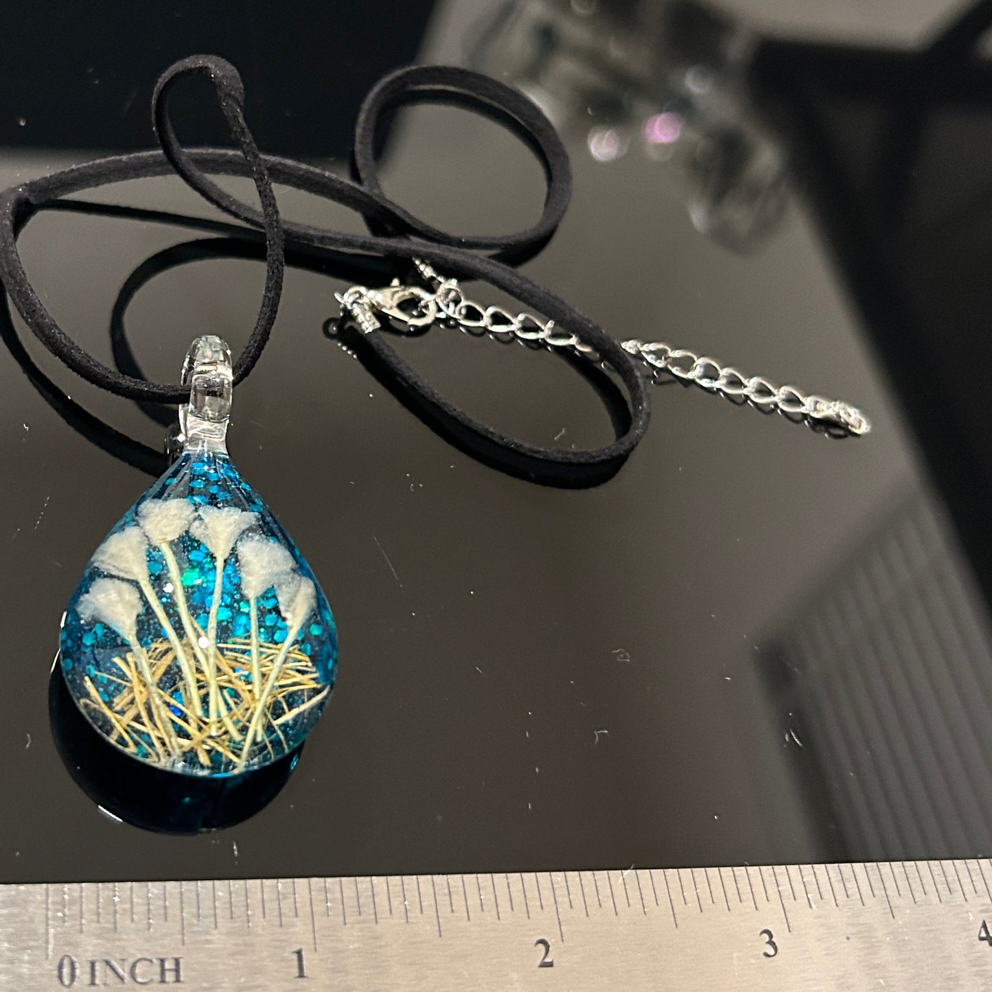 Handmade botanical dichroic glass teardrop pendant 2 inches with real dried grass straws suspended inside blue glass on 21 inch cloth chain