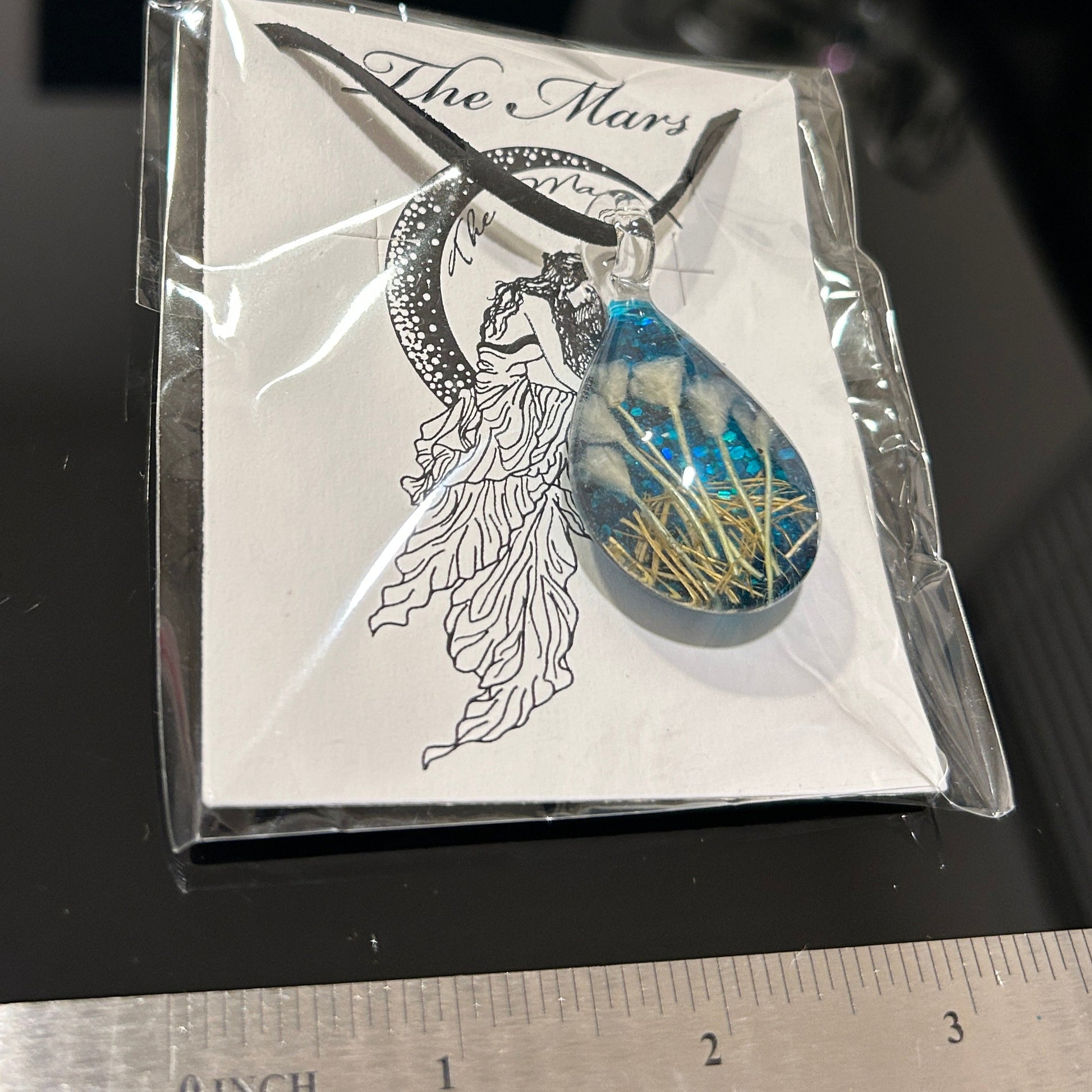 Handmade botanical dichroic glass teardrop pendant 2 inches with real dried grass straws suspended inside blue glass on 21 inch cloth chain