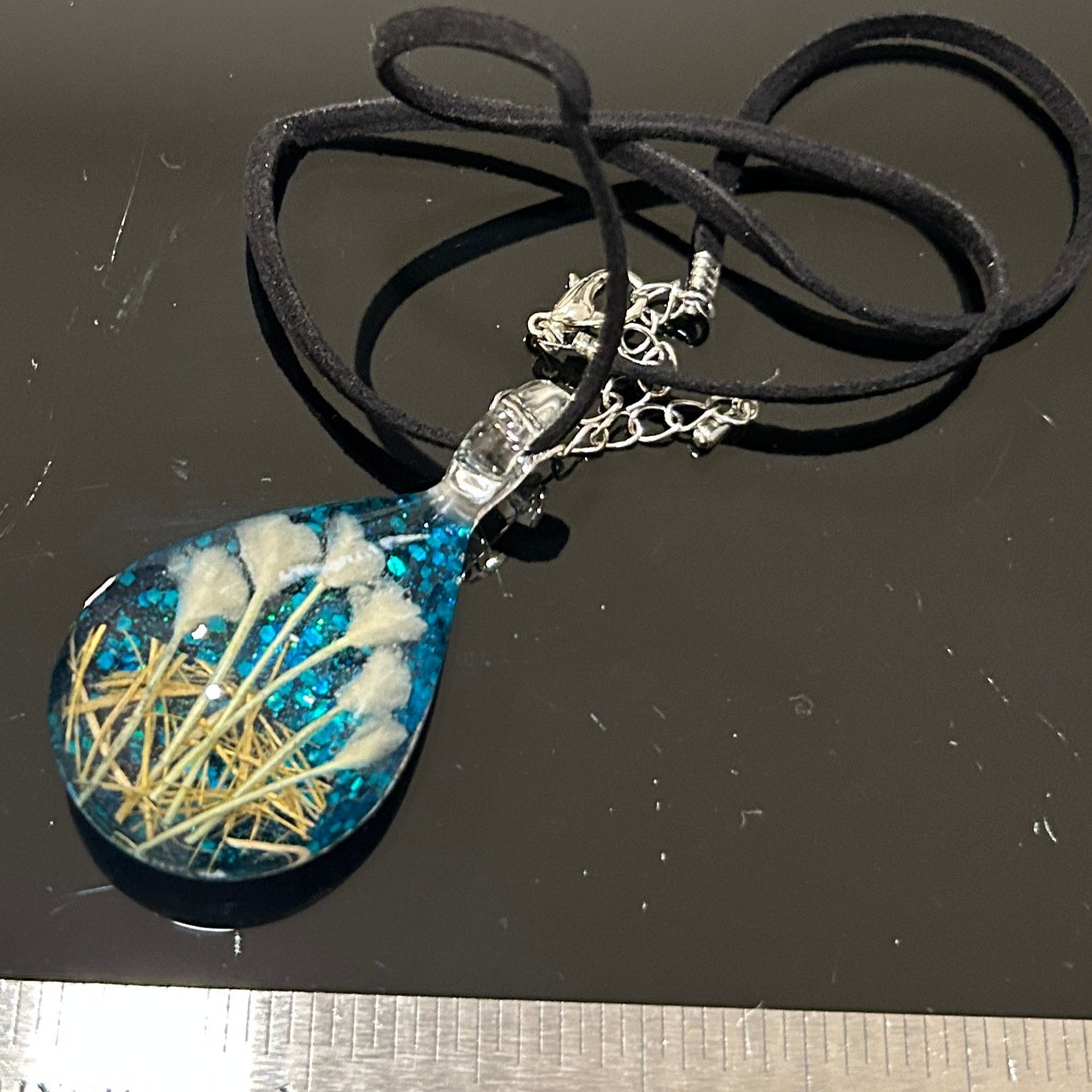 Handmade botanical dichroic glass teardrop pendant 2 inches with real dried grass straws suspended inside blue glass on 21 inch cloth chain