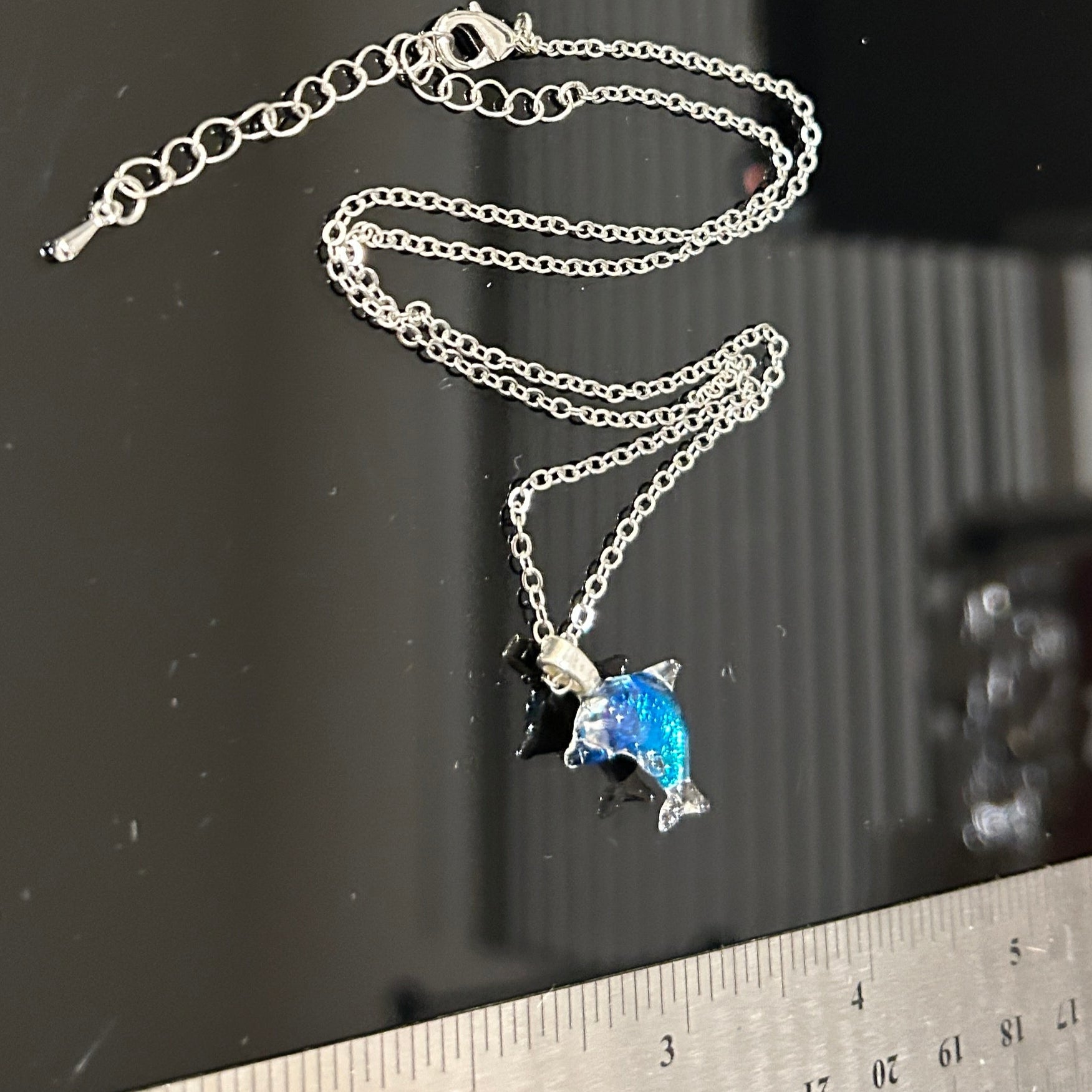Handmade dichroic glass dolphin pendant 1.25 inches with color-shifting blue effects on 21 inch sterling silver chain
