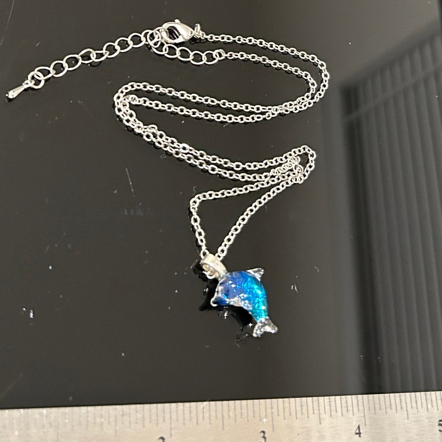Handmade dichroic glass dolphin pendant 1.25 inches with color-shifting blue effects on 21 inch sterling silver chain