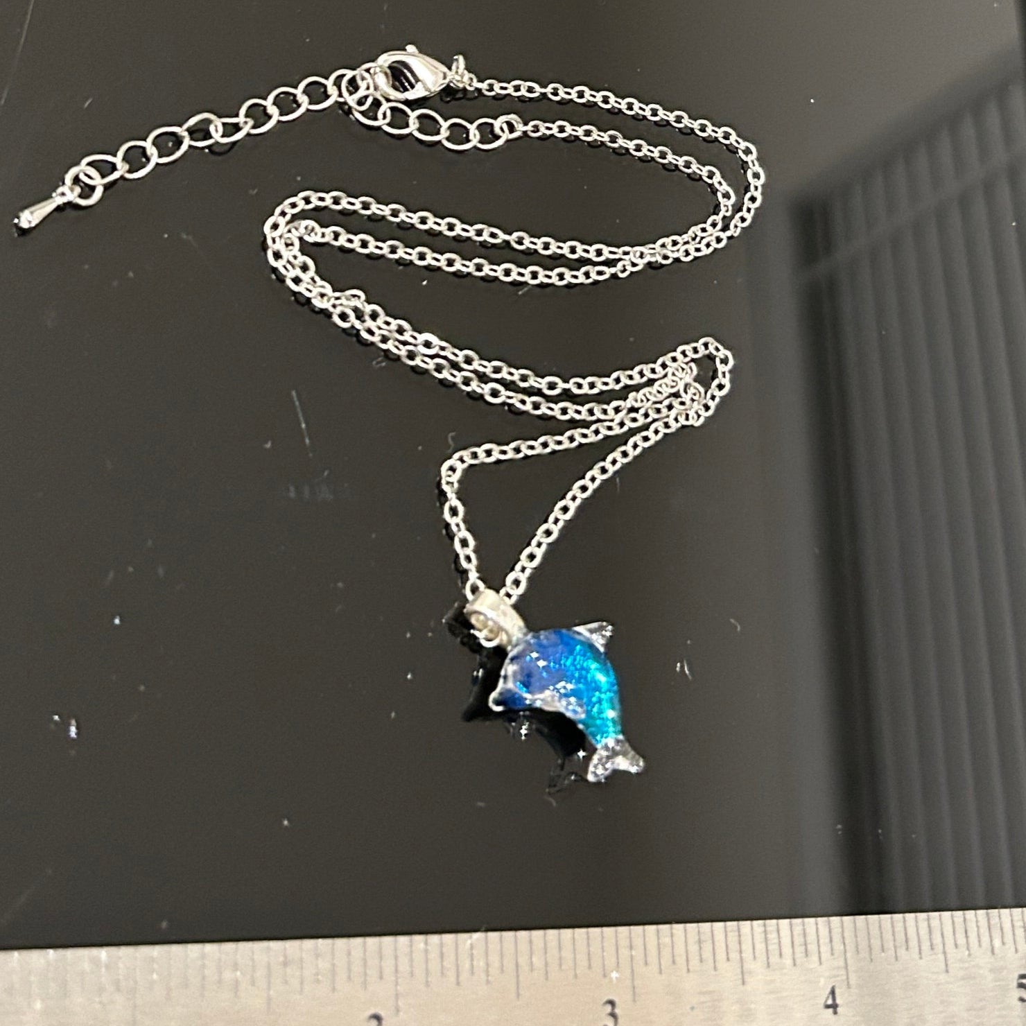 Handmade dichroic glass dolphin pendant 1.25 inches with color-shifting blue effects on 21 inch sterling silver chain