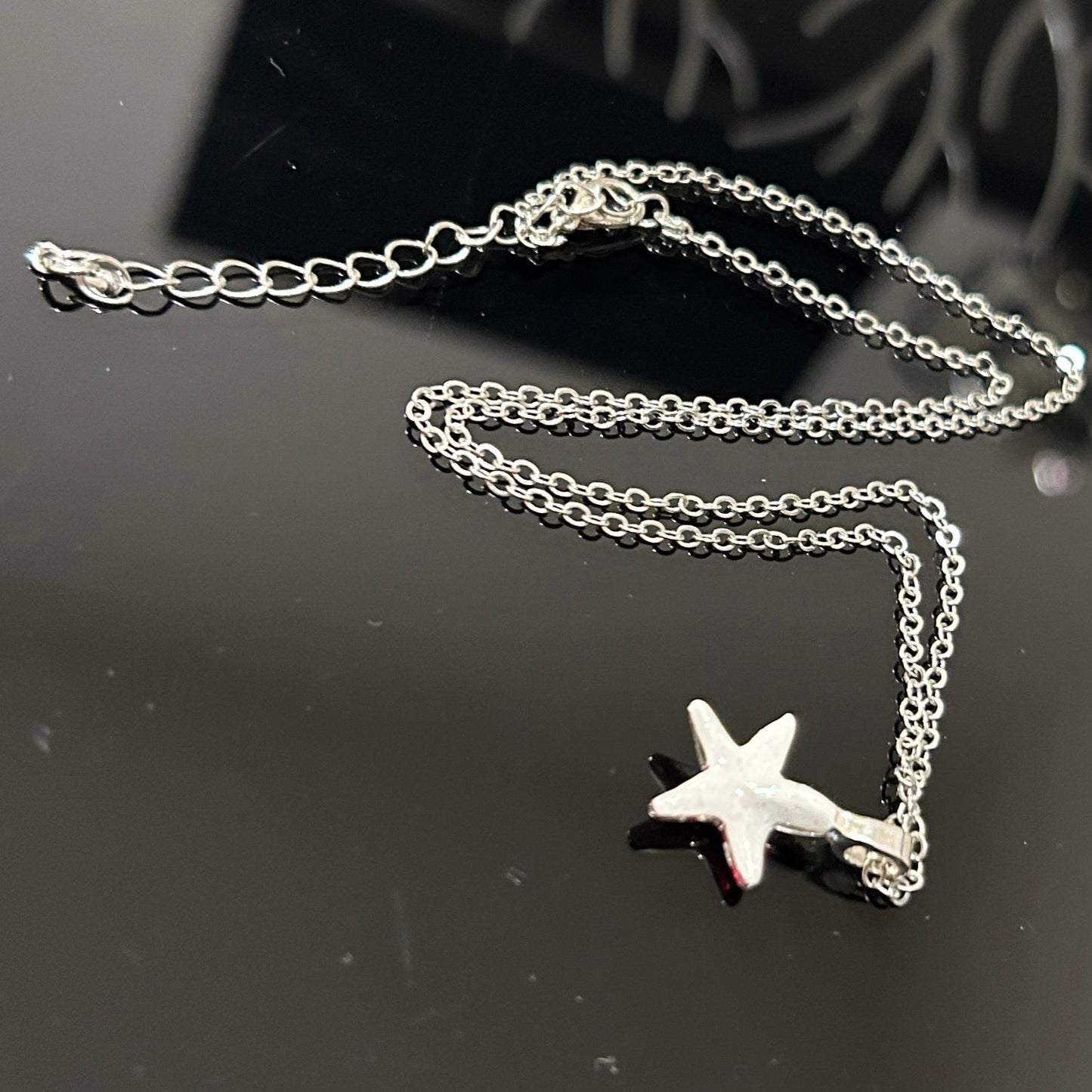 Handmade dichroic glass starfish pendant 1 inch with color-shifting pink effects on 21 inch sterling silver chain