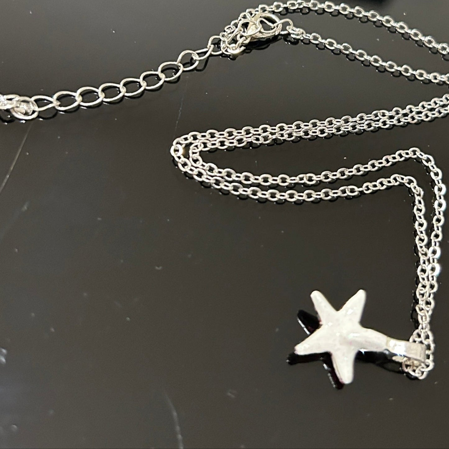 Handmade dichroic glass starfish pendant 1 inch with color-shifting pink effects on 21 inch sterling silver chain