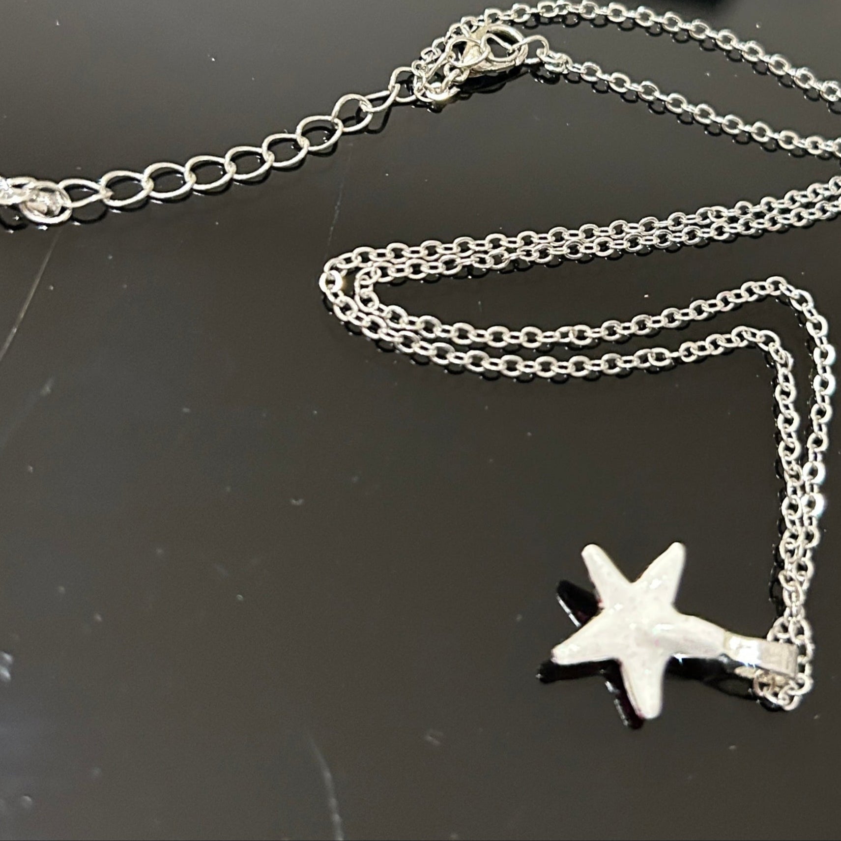 Handmade dichroic glass starfish pendant 1 inch with color-shifting pink effects on 21 inch sterling silver chain
