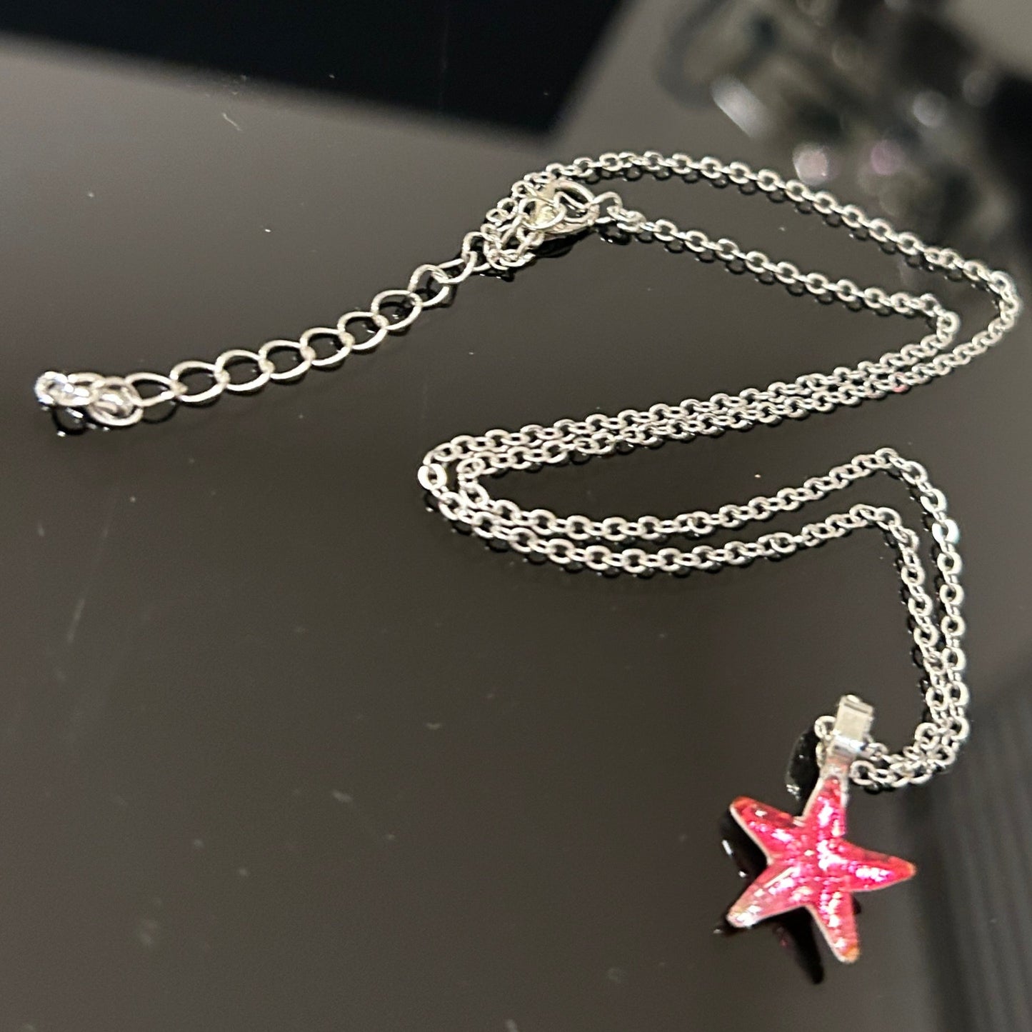 Handmade dichroic glass starfish pendant 1 inch with color-shifting pink effects on 21 inch sterling silver chain