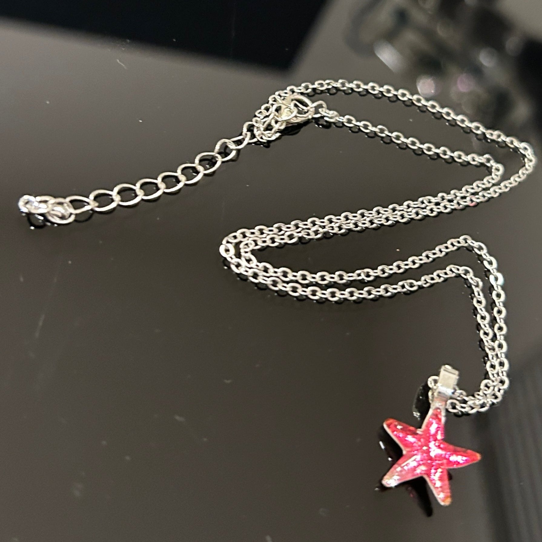 Handmade dichroic glass starfish pendant 1 inch with color-shifting pink effects on 21 inch sterling silver chain