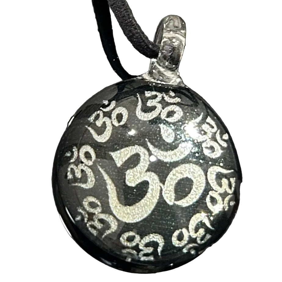 Handmade round black dichroic glass pendant with silver Om symbols sacred mantra yoga meditation spiritual jewelry on black satin cord necklace