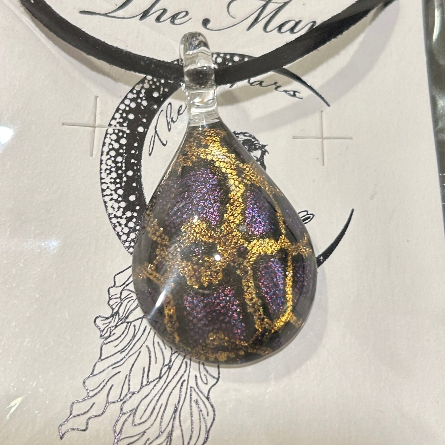 Handmade tree of life pendant in dichroic glass. 2 inches long, 1.25 inches wide. Blue and gold geometric design. Solid glass construction. 21" cloth cord included.