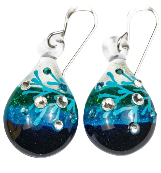 Pair of 1.125 inch handmade glass drop earrings with color gradient from cream to turquoise to deep blue, embedded crystal details, and sterling silver hooks